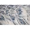 Grey and beige abstract background of wet sand texture formed by flowing water on beach