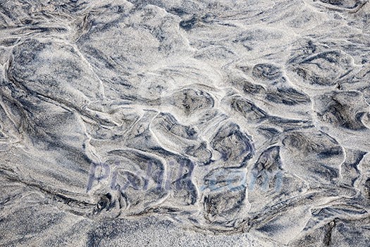 Grey and beige abstract background of wet sand texture formed by flowing water on beach Grey and beige abstract background of wet sand texture formed by flowing water on beach