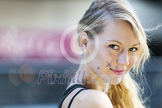 Portrait of young blonde smiling woman looking at camera with copy space Portrait of young blonde smiling woman looking at camera with copy space
