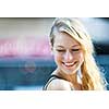 Candid portrait of young blonde woman laughing with copy space