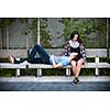Romantic interracial young couple relaxing on park bench outside