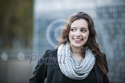 Candid portrait of young brunette woman smiling and looking to side with copy space Candid portrait of young brunette woman smiling and looking to side with copy space
