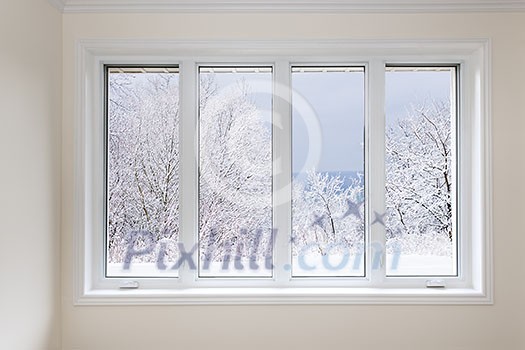 Large four pane window looking on snow covered trees in winter Large four pane window looking on snow covered trees in winter