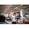Pretty, young woman choosing the right furniture for her apartment in a modern home furnishings store (color toned image; shallow DOF)