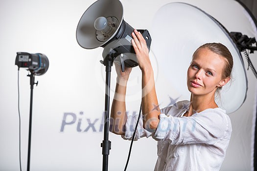 Pretty, female photographer with digital camera - DSLR and a huge telephoto lens (color toned image; shallow DOF) Pretty, female photographer with digital camera - DSLR and a huge telephoto lens (color toned image; shallow DOF)