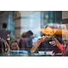 Pretty, young woman eating sushi in a restaurant, having her lunch break, enjoying the food, pausing for a while from her busy corporate/office life (color toned image)