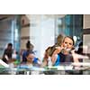 Pretty, young woman eating sushi in a restaurant, having her lunch break, enjoying the food, pausing for a while from her busy corporate/office life (color toned image)