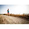 Young woman on her evening jog along the seacoast (motion blurred image)