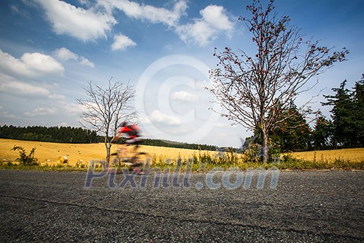 Motion blurred biker on a road Motion blurred biker on a road