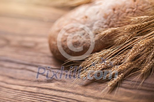 wheat and bread on wooden table, shallow DOF, raw image wheat and bread on wooden table, shallow DOF, raw image