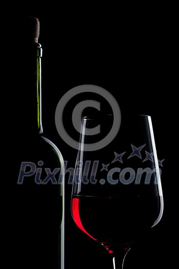 red wine in glass and bottle isolated on black red wine in glass and bottle isolated on black