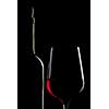 red wine in glass and bottle isolated on black