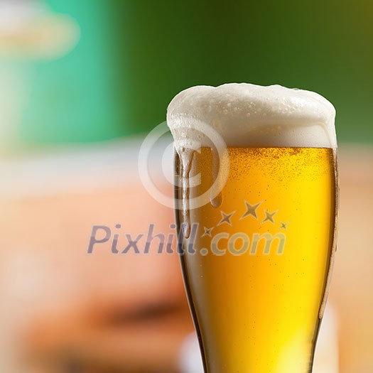 Glass of light beer in pub Glass of light beer in pub