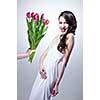 Smiling woman and hand with bouquet of pink tulips on white