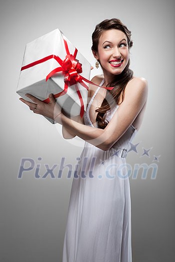 Young surprised smiling woman holding gift Young surprised smiling woman holding gift