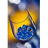 ice in wineglass on color background