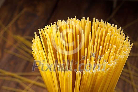 italian spaghetti on wooden background. Top view italian spaghetti on wooden background. Top view