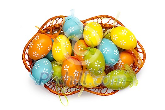 color easter eggs in basket isolated on white. top view color easter eggs in basket isolated on white. top view