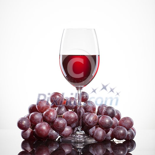 Glass of red wine and grape isolated on white background Glass of red wine and grape isolated on white background