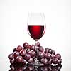 Glass of red wine and grape isolated on white background