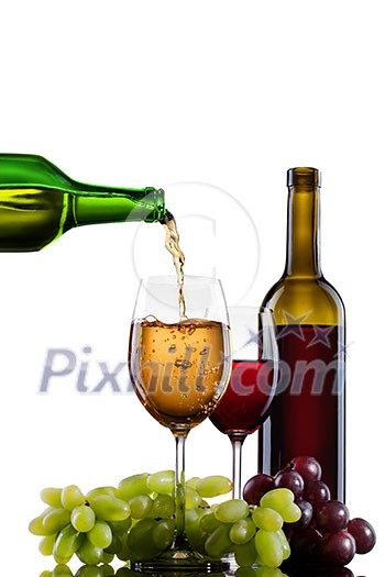 White wine pouring into glass with grape and bottles isolated White wine pouring into glass with grape and bottles isolated