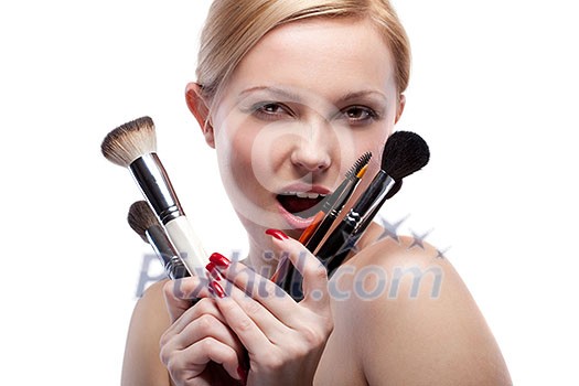 Young smiling woman with make up brushes isolated on white Young smiling woman with make up brushes isolated on white