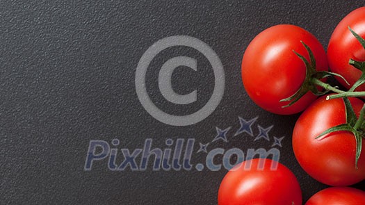 red tomatoes on black. Top view. Header for website red tomatoes on black. Top view. Header for website