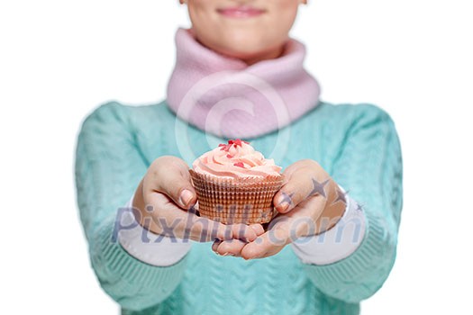 Young woman holding a pink cupcake decorated with hearts, isolated on white background Young woman holding a pink cupcake decorated with hearts, isolated on white background