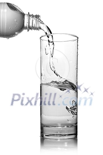 water pouring into glass from bottle isolated on white water pouring into glass from bottle isolated on white