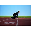 business man in start position ready to run and sprint on athletics racing track