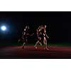 woman athletic runners passing baton in relay race