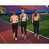 athlete woman group  running on athletics race track on soccer stadium and representing competition and leadership concept in sport