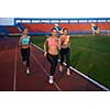 athlete woman group  running on athletics race track on soccer stadium and representing competition and leadership concept in sport