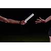 woman athletic runners passing baton in relay race