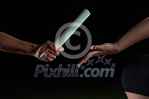 woman athletic runners passing baton in relay race woman athletic runners passing baton in relay race