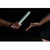 woman athletic runners passing baton in relay race