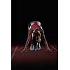 woman  sprinter leaving starting blocks on the athletic  track. Side view. exploding start