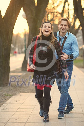 Happy and young pregnant couple have fun and relax outdoor
