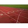 Red athletic track treadmill at the stadium with the numbering.