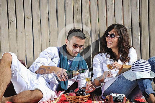 happy young couple enjoying picnic on the beach and have good time on summer vacations happy young couple enjoying picnic on the beach and have good time on summer vacations