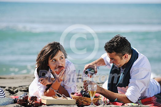 happy young couple enjoying picnic on the beach and have good time on summer vacations happy young couple enjoying picnic on the beach and have good time on summer vacations