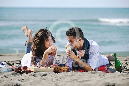 happy young couple enjoying picnic on the beach and have good time on summer vacations happy young couple enjoying picnic on the beach and have good time on summer vacations