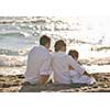 happy young family in white clothing have fun at vacations on beautiful beach 