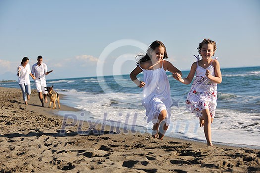 happy young family in white clothing have fun and play with beautiful dog at vacations on beautiful beach happy young family in white clothing have fun and play with beautiful dog at vacations on beautiful beach