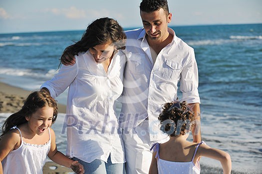 happy young family in white clothing have fun at vacations on beautiful beach happy young family in white clothing have fun at vacations on beautiful beach