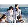happy young family in white clothing have fun at vacations on beautiful beach 