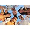 happy young friends group team huging have fun and celebrate  on the beach at the sunset