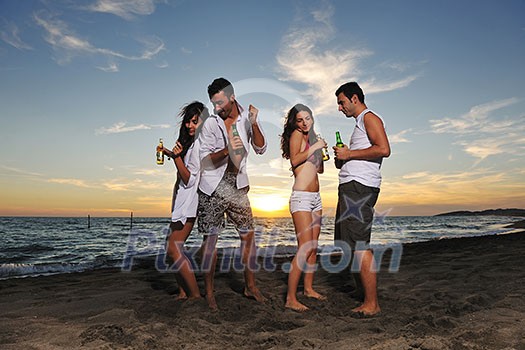 happy young friends group have fun and celebrate while jumping and running on the beach at the sunset happy young friends group have fun and celebrate while jumping and running on the beach at the sunset
