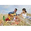 happy young couple enjoying  picnic on the countryside in the field  and have good time