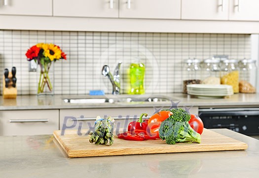 Modern kitchen interior with fresh vegetables on natural stone countertop Modern kitchen interior with fresh vegetables on natural stone countertop